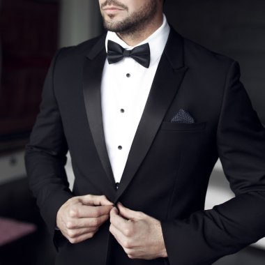 Sexy man in tuxedo and bow tie clipart