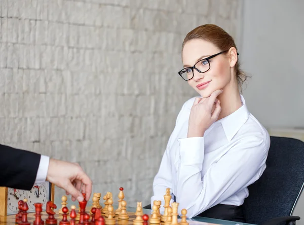 Confident woman winning chess game