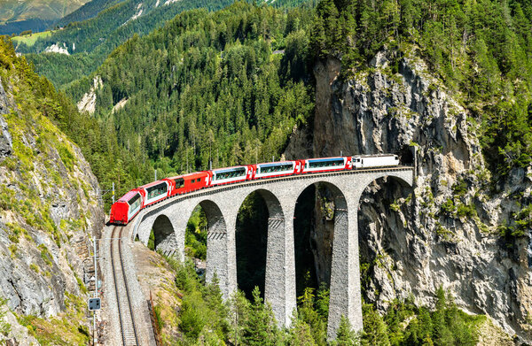 Passenger train crossing the Landwasser Viaduct in Switzerland