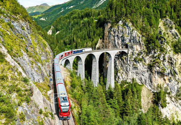 Passenger train crossing the Landwasser Viaduct in Switzerland