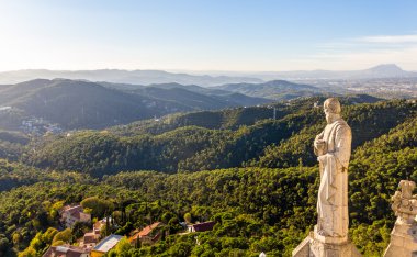 Sculpture Apostle and mountains near Barcelona clipart