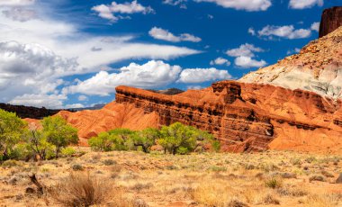 Castle kaya oluşumu, Utah 'taki Capitol Reef Ulusal Parkı' ndaki Fremont Nehri Vadisi 'nin üzerinde yükselir. Manzarada dikey Wingate Sandstone uçurumları ve renkli Chinle oluşum eğimleri yer almaktadır.