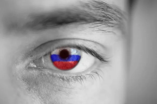 Men portrait with eyes the color of Russia flag