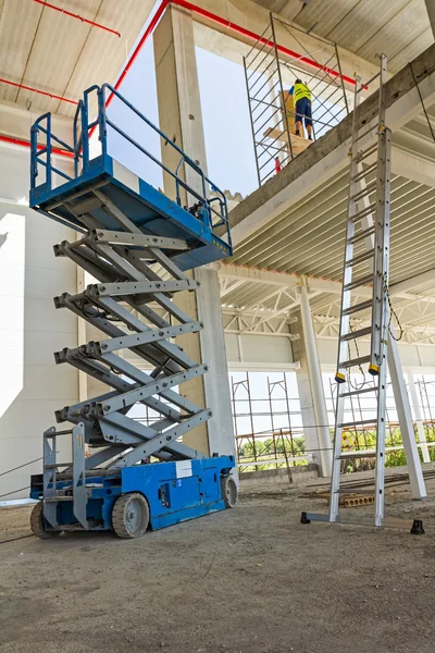 Plataforma elevadora de tijera en una obra de construcción . —  Fotos de Stock