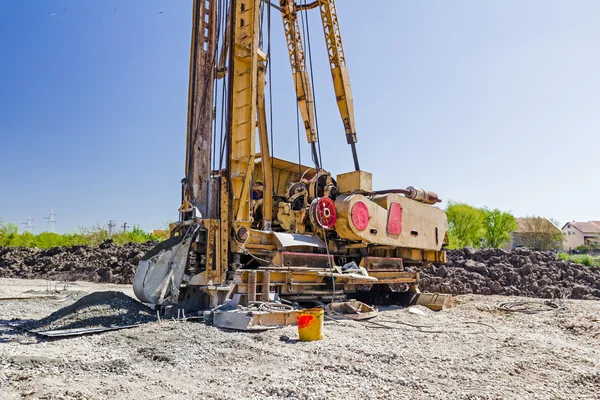 Lugar de construcción con equipo grande para perforar en el suelo — Foto de Stock