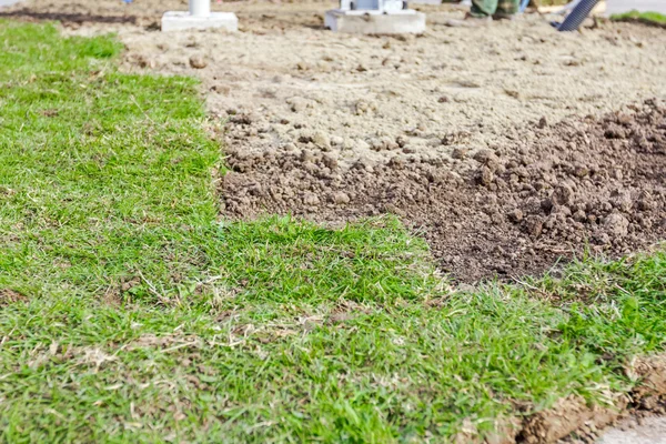 Partially placed sod for new lawn, unrolling grass — Stock Photo, Image