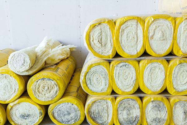 Stack of thermal insulation material in roll is wrapped with cel