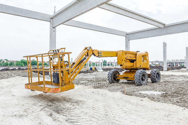 Orange cherry picker. Boom lift