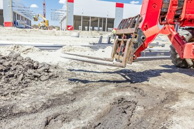 Arka planda Bina sitesindeki Yükleyici-Teleskop forklift