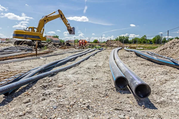 Front view on long black water HDPE pipe with blue stripe at con — Stock Photo, Image