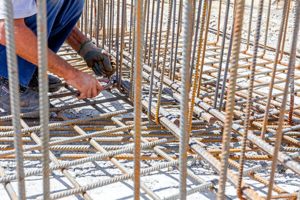 Construction workers binding rebar for reinforce concrete column