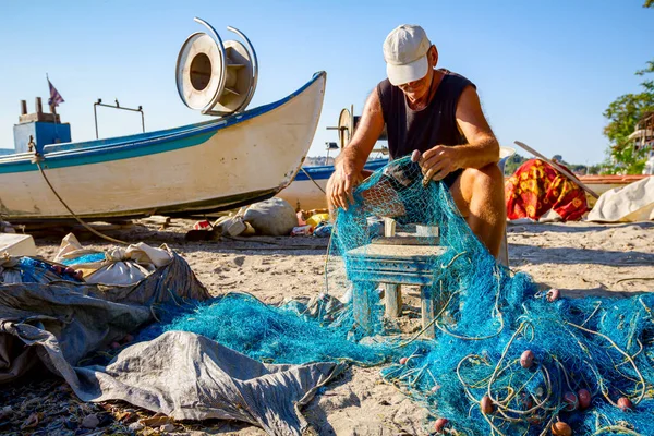 Een Visser Zit Een Stoel Aan Het Strand Stapelt Het — Stockfoto