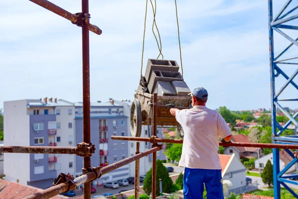 Worker Helping Crane Keep Balance Direction Transport Wheelbarrow Laden Blocks — Stock Photo, Image