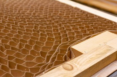 Perforated pasteboard for soundproof insulating door is in the carpentry workshop.