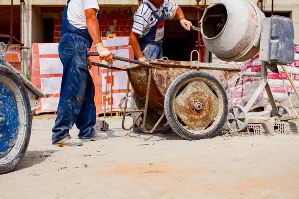 Workers Pour Mortar Wheelbarrow Attached Crane Hooks Carry Transport — Stock Photo, Image