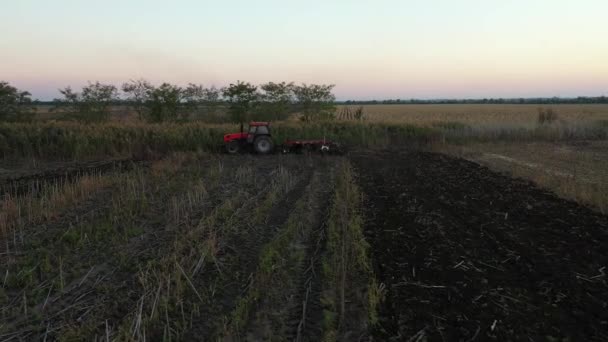 Dolly Move Backwards Shot Tractor Pulling Machine Harrowing Arable Field — Stock Video