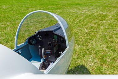 Sailplane with opened cockpit hood of glass resting clipart