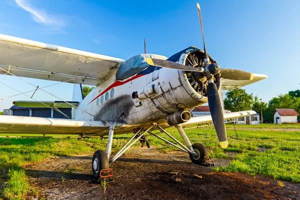 Biplane standing at sunset