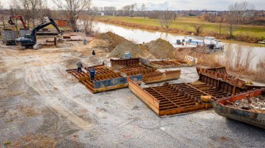 Above view on workers as they cutting parts of old large vessel into smaller pieces, barge, dismantling ship, cut out rusty metal for scarp, using acetylene torch, recycling, sparks are fly around.