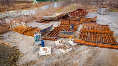 Above view on workers as they cutting parts of old large vessel into smaller pieces, barge, dismantling ship, cut out rusty metal for scarp, using acetylene torch, recycling, sparks are fly around.