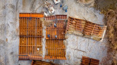 Above top view on workers as they cutting parts of old large vessel into smaller pieces, barge, dismantling ship, cut out rusty metal for scarp, using acetylene torch, recycling, sparks are fly around.