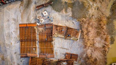 Above top view on workers as they cutting parts of old large vessel into smaller pieces, barge, dismantling ship, cut out rusty metal for scarp, using acetylene torch, recycling, sparks are fly around.