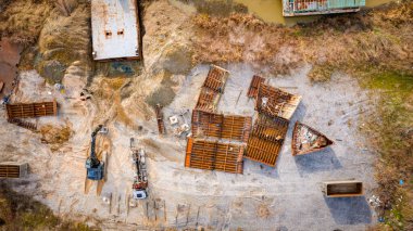 Above top view on workers as they cutting parts of old large vessel into smaller pieces, barge, dismantling ship, cut out rusty metal for scarp, using acetylene torch, recycling, sparks are fly around.