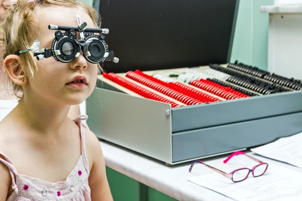 Menina está no optometrista, escritório de óptica fazendo olho chec — Fotografia de Stock