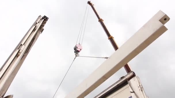 Mobile crane is unloading concrete joist from truck trailer. — Stock Video