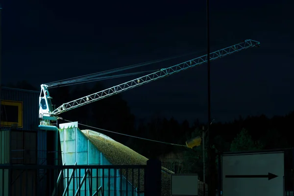 Crane with shovel at night