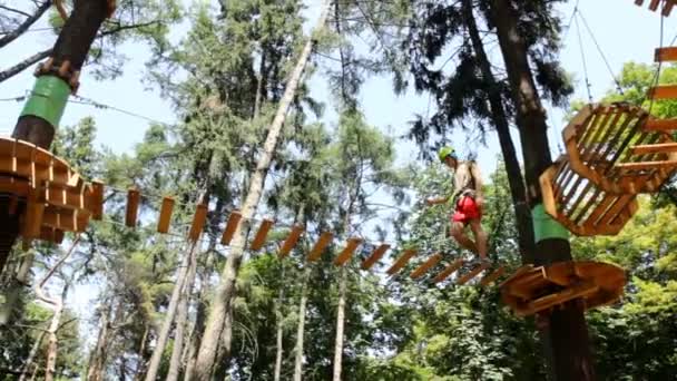 Homme escalade dans le parc d'aventure 