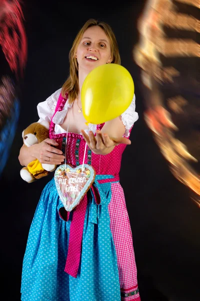 Woman in dirndl enjoying fun fair — Stock Photo, Image