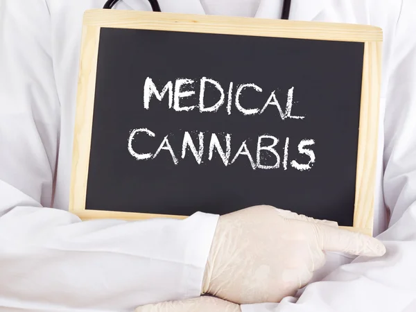 Doctor shows information on blackboard: medical cannabis — Stock Photo, Image