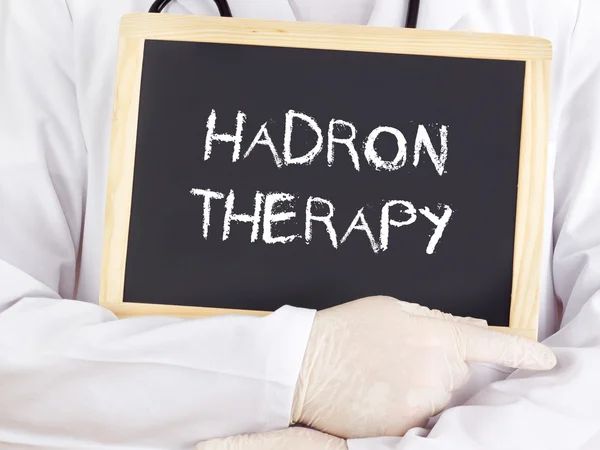 Doctor shows information: hadron therapy — Stock Photo, Image