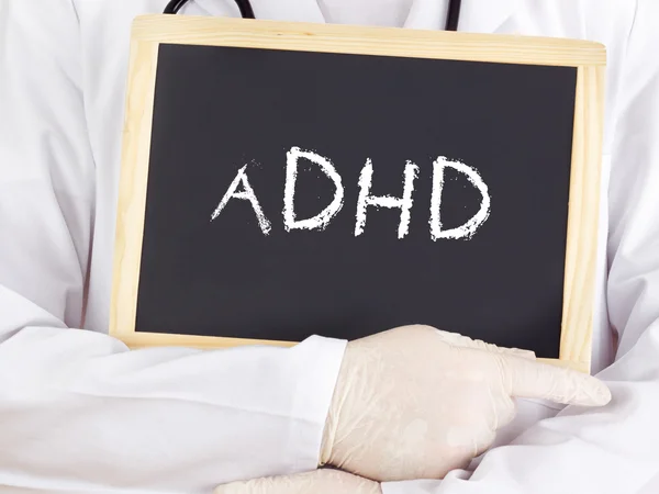 Doctor shows information on blackboard: adhd — Stock Photo, Image