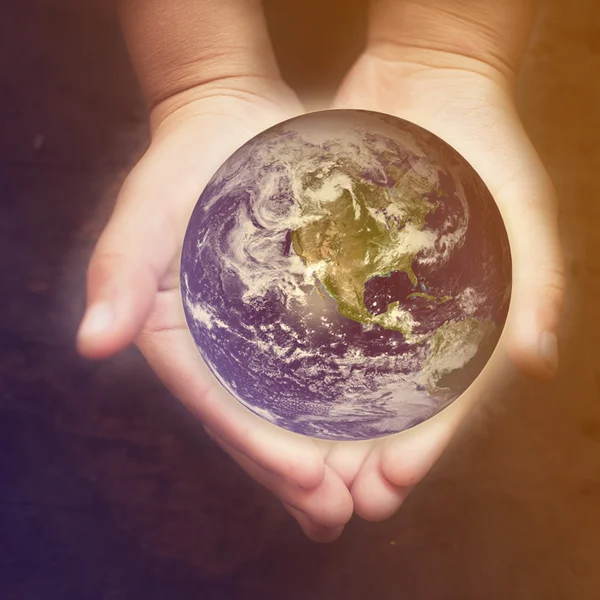 Child holding a glowing earth globe — Stock Photo, Image