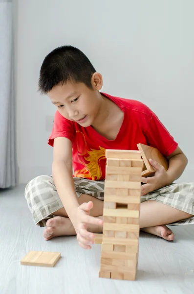 Asian children playing wooden blocks at home. — Stock Photo, Image