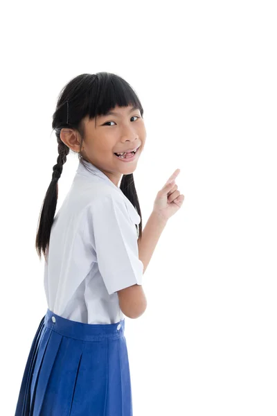 Cute Asian girl in uniform showing her broken teeth on white bac Stock Picture