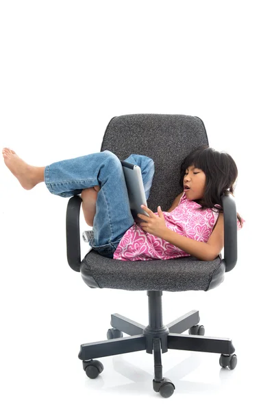 Söt flicka sitter på en stol — Stockfoto