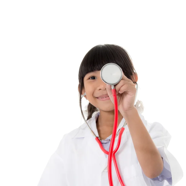 Asian girl in doctor's coat and holding stethoscope on white — Stock Photo, Image