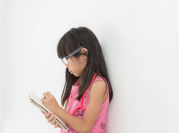 Cute Asian girl playing doctor at home. — Stock Photo, Image