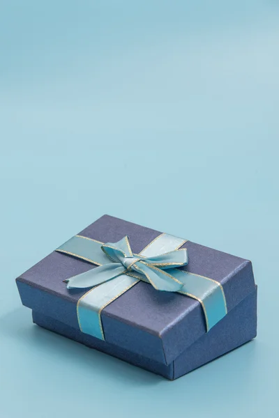 Blue gift box on blue colour background — Stock Photo, Image