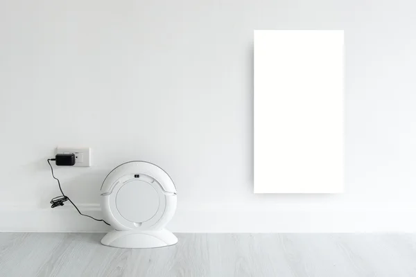 Mock up white discard with Cleaning robot charging at white wall — Stock Photo, Image