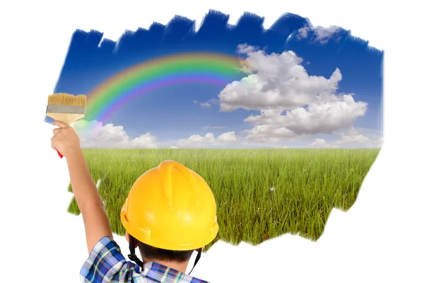 Young child boy painting blue sky and green field over white wal — Stock Photo, Image