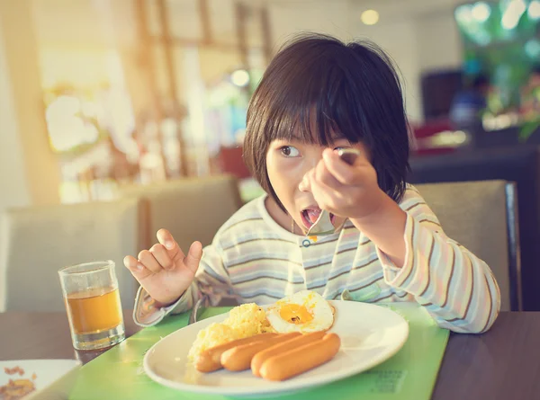 Asian girl eating breakfast with pajamas. — Stock Photo, Image