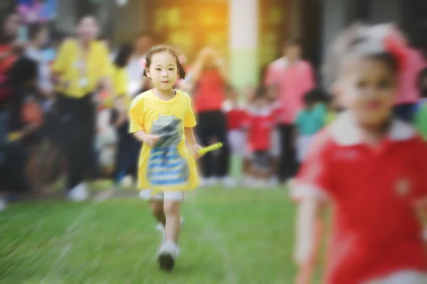 Blurry background Cute Asian girl running in sport day. — Stock Photo, Image