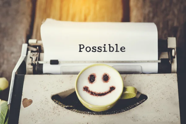 Typewriter with happy face coffee cup, sepia tone. — Stock Photo, Image