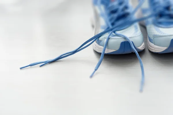 Вибірковий фокус крупним планом блакитне спортивне взуття на сірій підлозі . — стокове фото