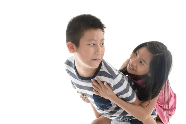 Joyful older brother giving younger sister a piggy bag while pla — Stockfoto