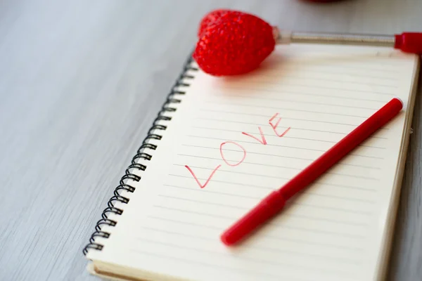 Love message on notebook on gray floor — Stock Photo, Image